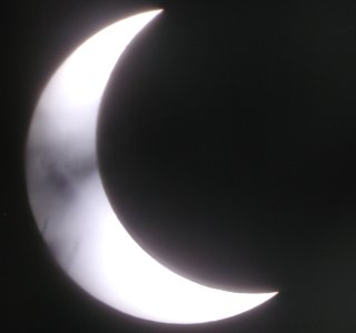picture, eclipse through some branches.